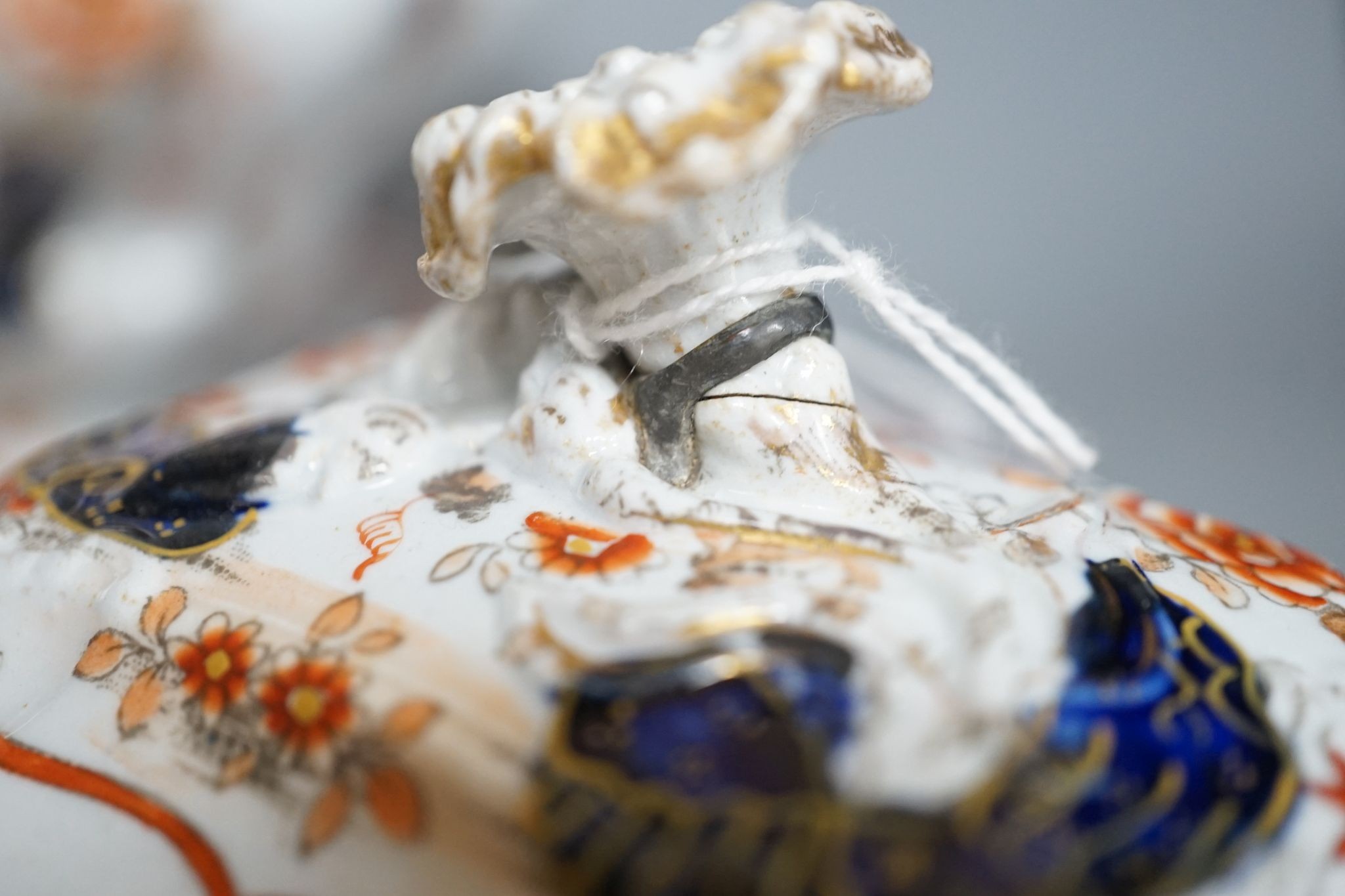 An early 19th century stone china soup tureen and cover on stand, decorated in cobalt blue and iron red, a similar tureen, a pair of small covered dishes, Staffordshire spaniels, etc.